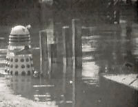 [Dalek rising from water]